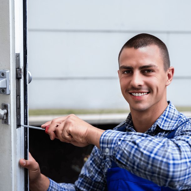 locksmith man smiling while holding a tool