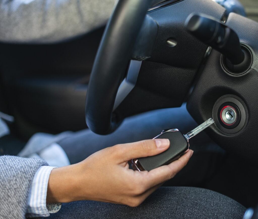 car owner holding a key inside the car