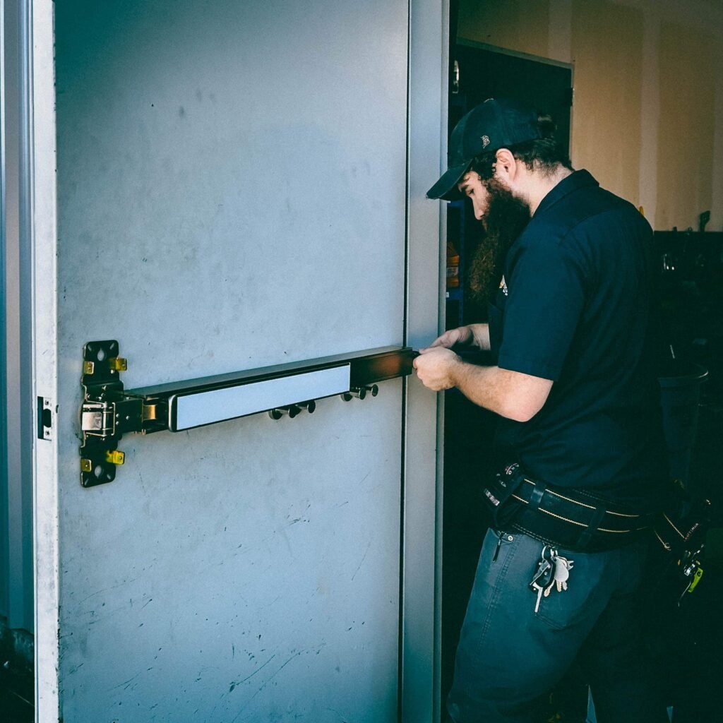 a man fixing a Panic Bar and Exit Device
